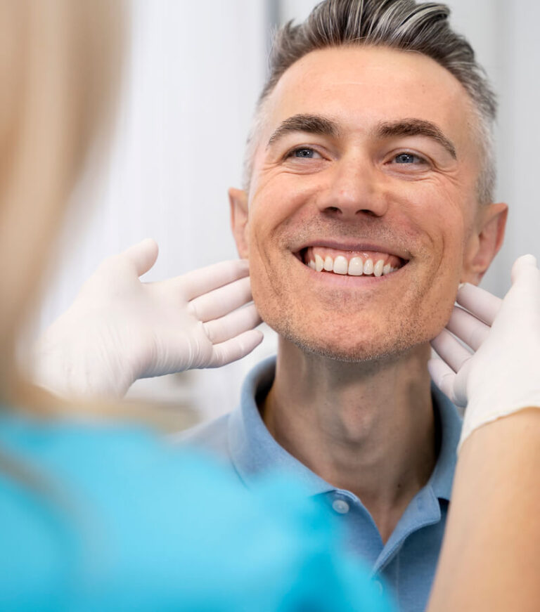 En tandlæge er i gang med at lave tandbroer på patient